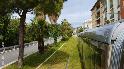 Nice train moving on railways along green trees, passengers transportation