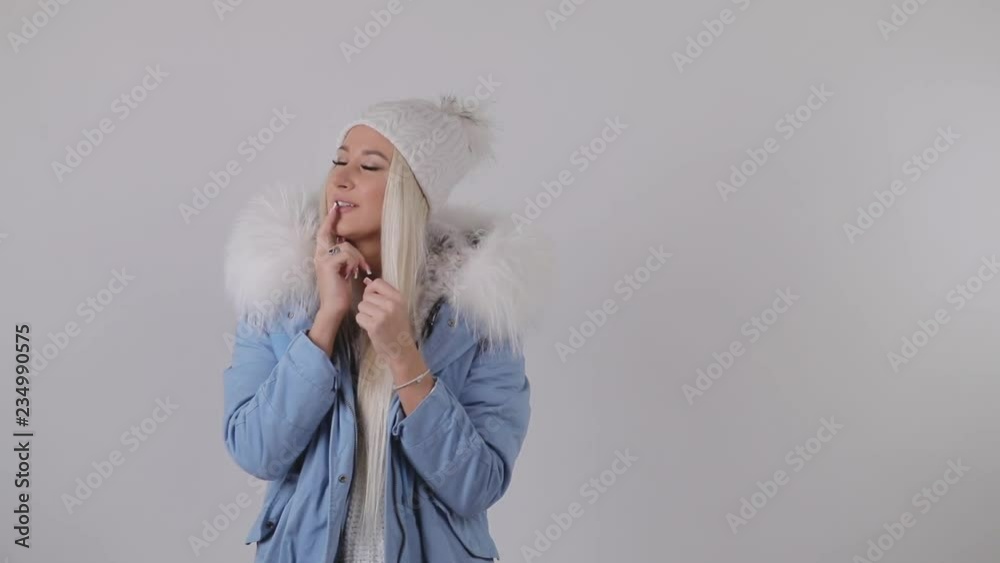 Happy Amazed Woman in winter fur coat, Holding Present in Her Hands, makes a wish and gets a gift box. White background. 4k slow motion video
