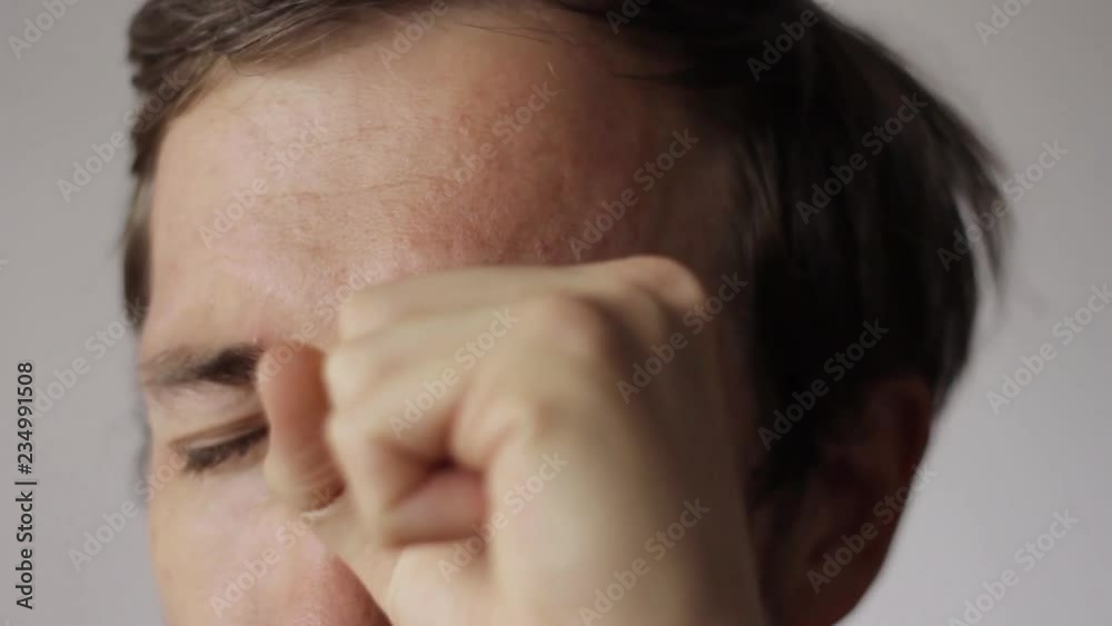 Showing a magic trick with his eyeball after looking through the hole. Showing a magic trick with his eyeball after looking through the hole.