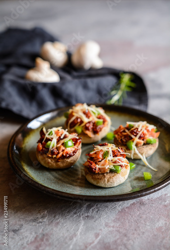 Roasted mushrooms stuffed with ham, sun dried tomato and bell pepper
