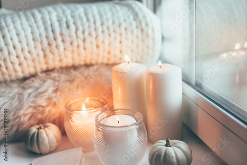 Hygge scene with sweater and candles