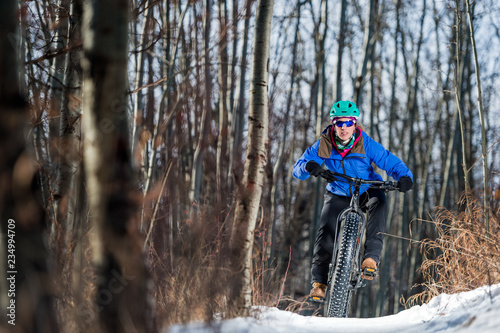 Woman riding a fat bike in the snow