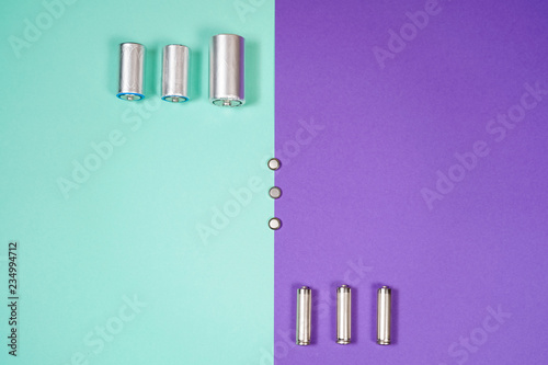 Many different types used or new battery, rechargeable accumulator, alkaline batteries on color background.