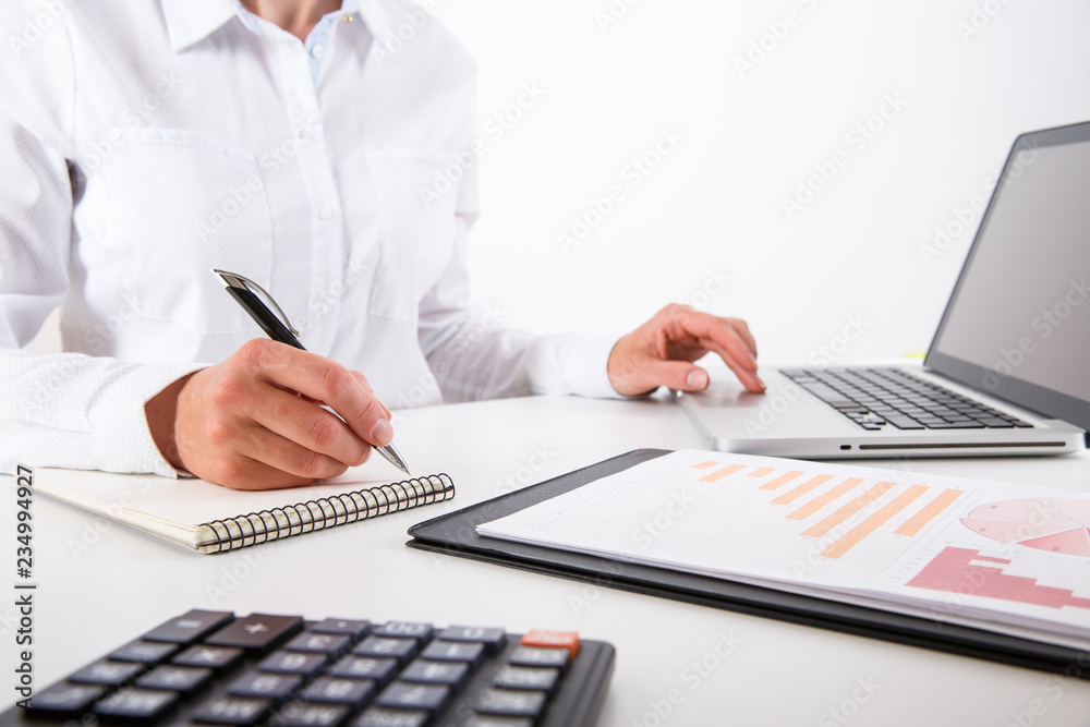 Business woman pointing at graph document close-up.