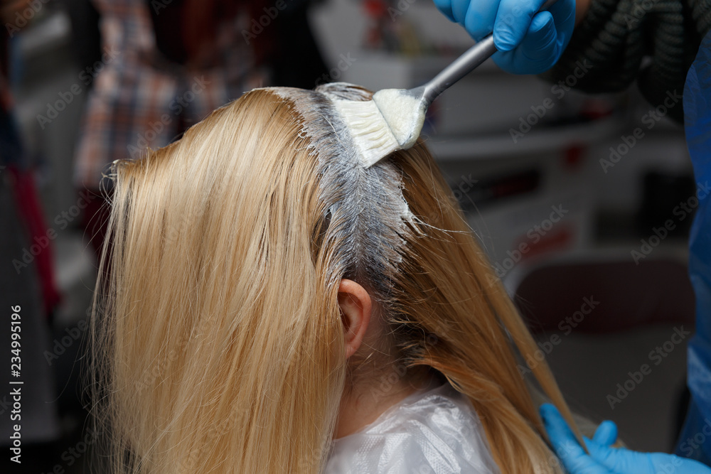 Fototapeta premium Woman dyeing hair