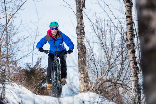 Woman riding a fat bike in the snow