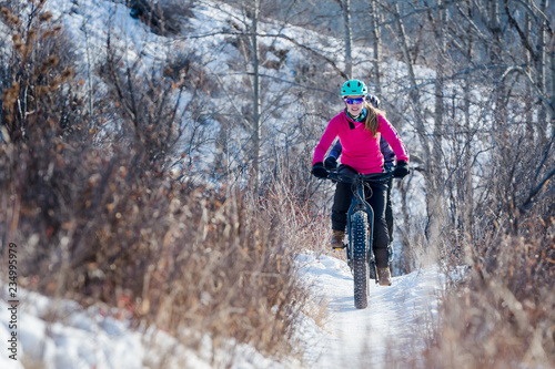 Woman riding a fat bike in the snow