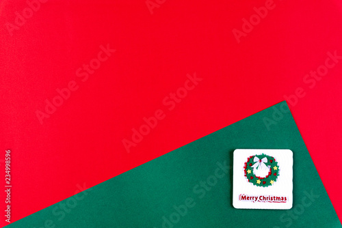 Christmas background concept. Top view of Christmas tree decoration on red and green paper background, flat lay with copy space.