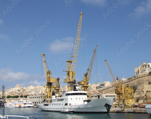 Ships and port cranes in the port in Malta