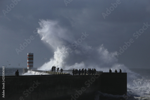 Big storm with big waves near a lighthouse