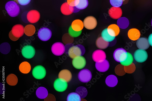 Blurred vibrant bokeh circles abstract background on black