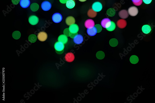 Blurred bokeh defocused festive lights. abstract background on black