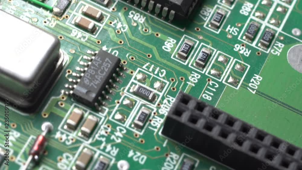 Circuit board with components in rotation. Close up of green printed electronic board, with components. Circuit board with components in rotation. Close up of green printed electronic board, with components.