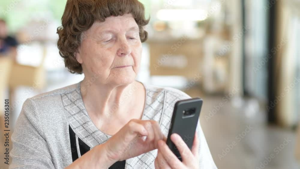 Beautiful Senior Woman Using Phone At The Coffee Shop Beautiful Senior Woman Using Phone At The Coffee Shop