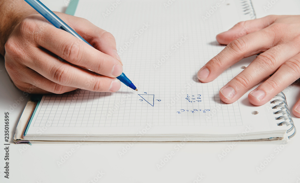 The man solves the mathematical task using the pitagoras pattern. Solving mathematical tasks, learning mathematics. Concept of problems with counting, patterns. The man solves the mathematical task using the pitagoras pattern. Solving mathematical tasks, learning mathematics. Concept of problems with counting, patterns.