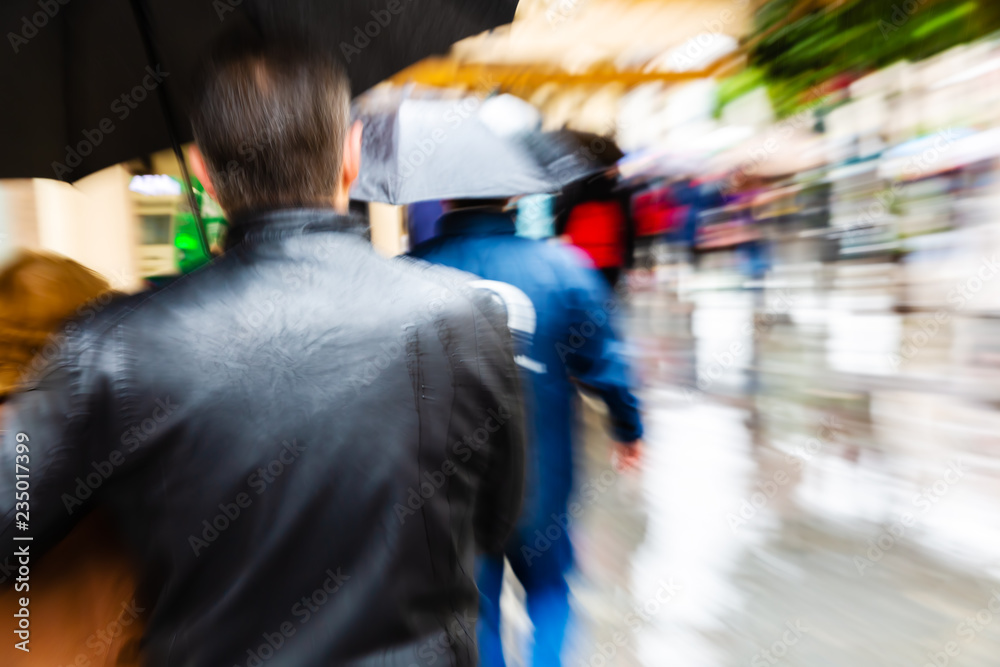 people with umbrellas in the rainy city with zoom effect people with umbrellas in the rainy city with zoom effect