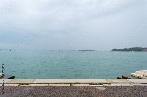 The lagoon of Venice on a rainy and cold day. No people around  no boats around  just sky and water