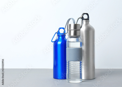 Different sport bottles with space for text on white background