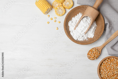 Flat lay composition with corn starch and space for text on white wooden background