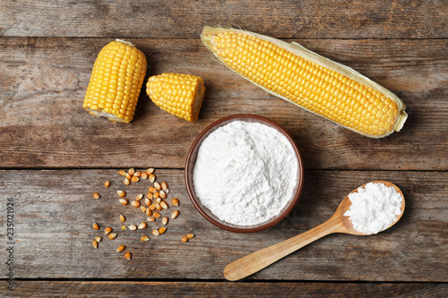 Flat lay composition with corn starch on wooden background