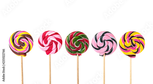 Different tasty colorful candies on white background