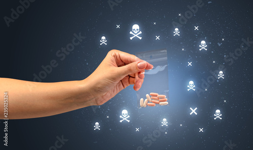 Female handing over pills with skull concept  photo