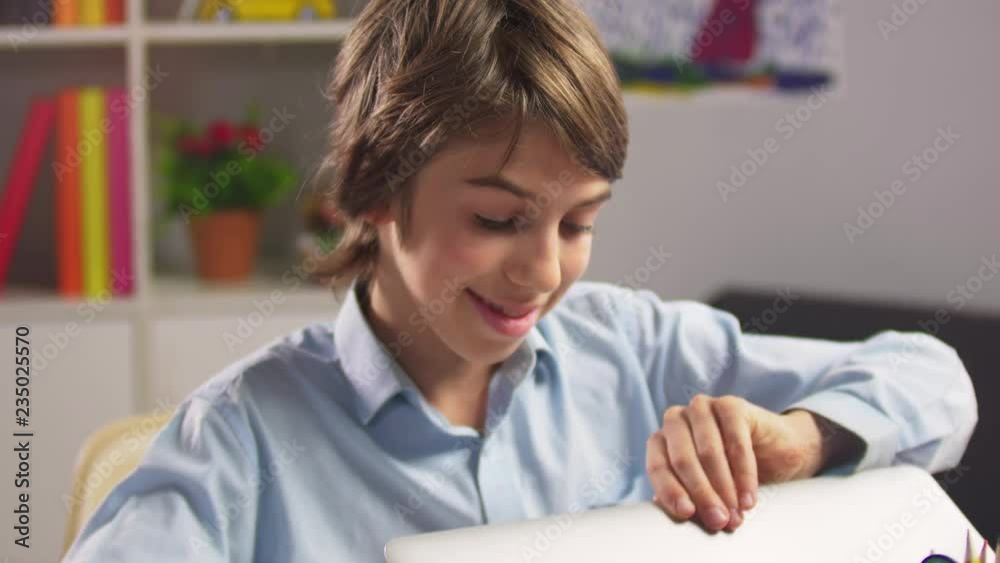 Portrait of student boy opening laptop computer Portrait of student boy opening laptop computer