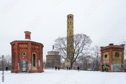 Outdoor scenery of the park covered with snow and old brick water tower in Kollwitzkiez, Berlin, Germany. photo