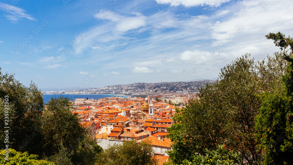 Old town of Nice, France between trees, viewed from Castle Hill