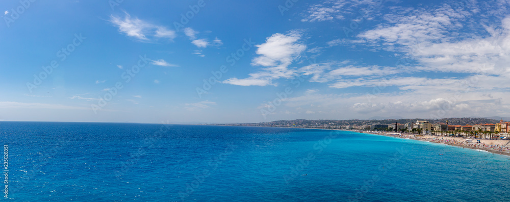 Panorama of beach and city of Nice, France, by the blue sea