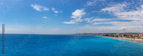 Panorama of beach and city of Nice, France, by the blue sea