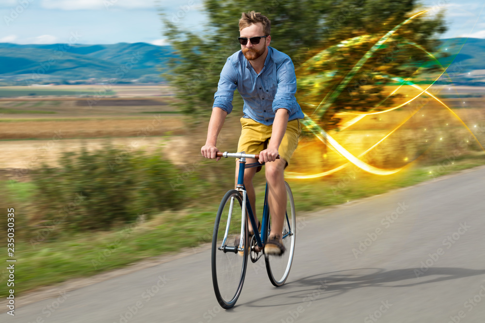 Naklejka premium Young cyclist riding bicycle with magical landscape and concept