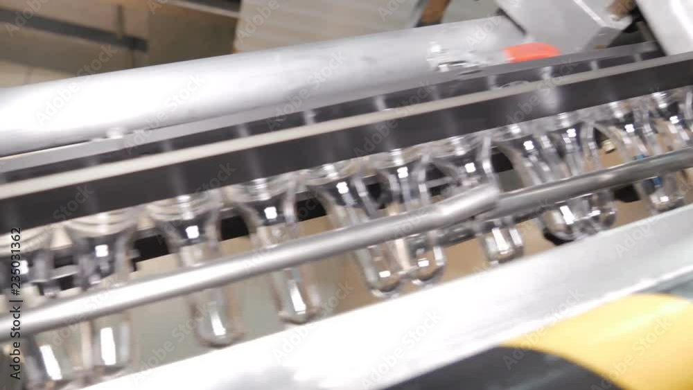 Plastic preform bottles move through the machine for blowing Plastic preform bottles move through the machine for blowing
