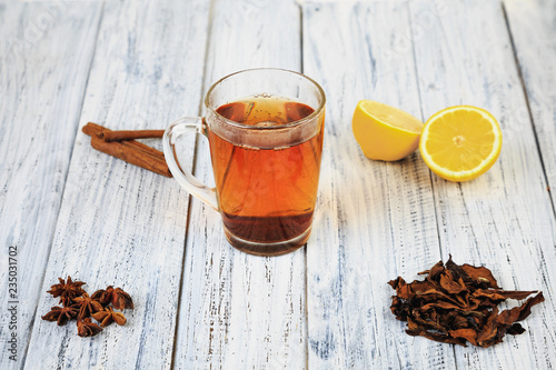 hot tea, cinnamon sticks, star anise, dried tea leaves and orange