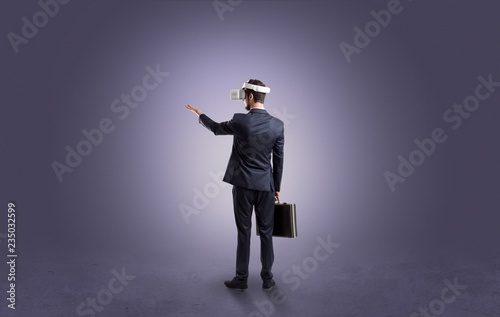 Businessman wearing vj glasse in an empty room with no wallpaper