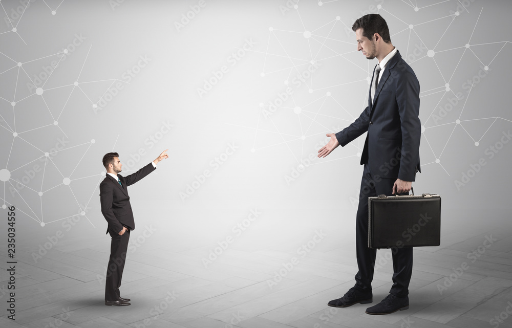Fototapeta premium Small businessman aiming at a big businessman with connection and network concept 