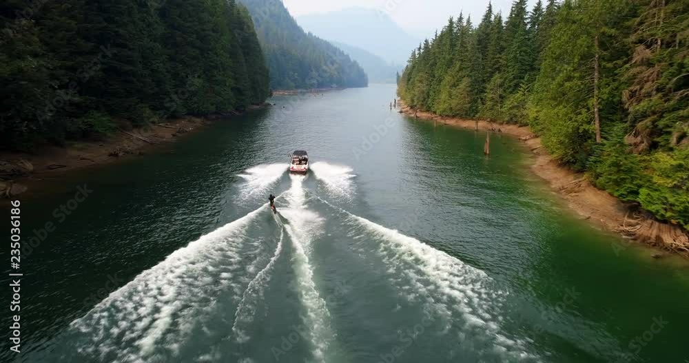 Man wakeboarding with motorboat in the river 4k