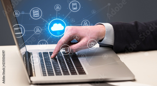 Businessman hand typing with cloud technology system and office symbol concept
