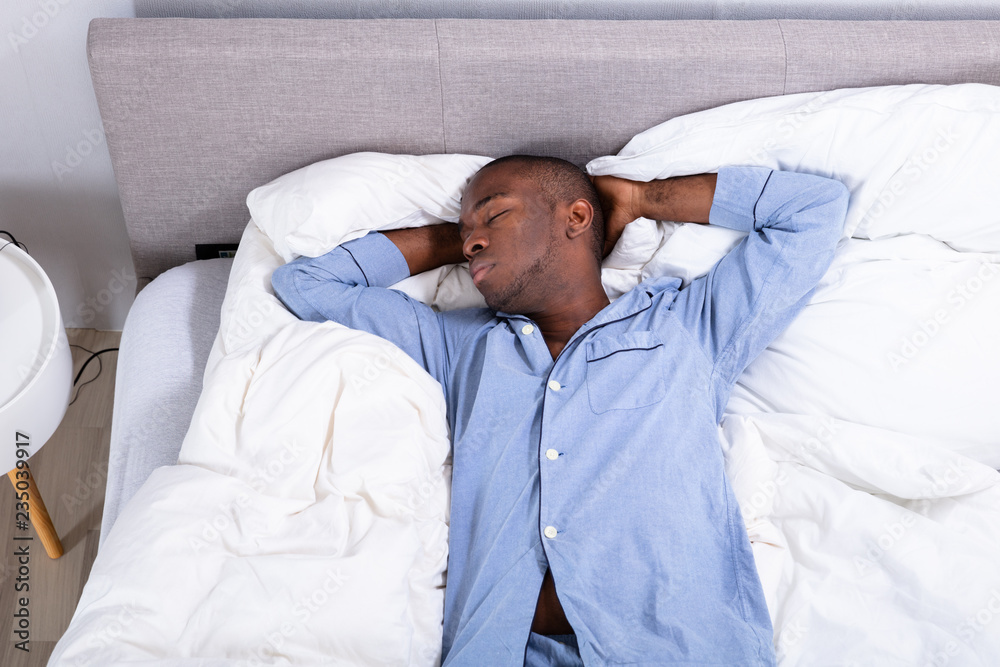 High Angle View Of Man Sleeping On Bed High Angle View Of Man Sleeping On Bed