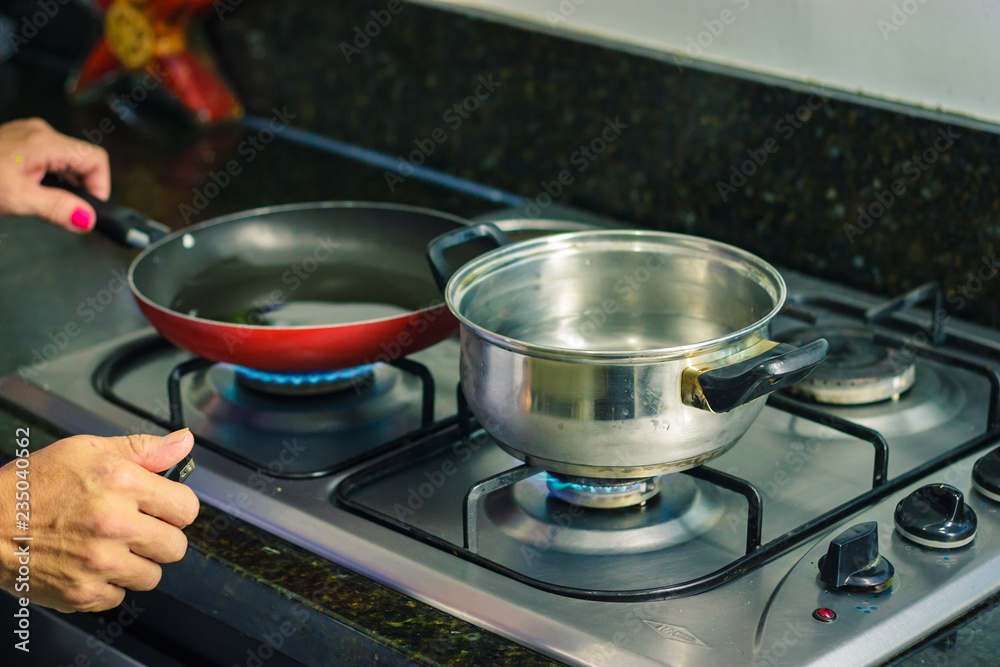 Hands turnging on a stove Hands turnging on a stove