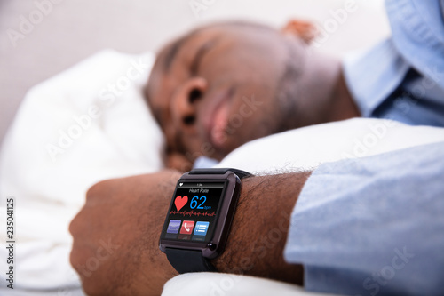 Man Sleeping With Smart Watch In His Hand