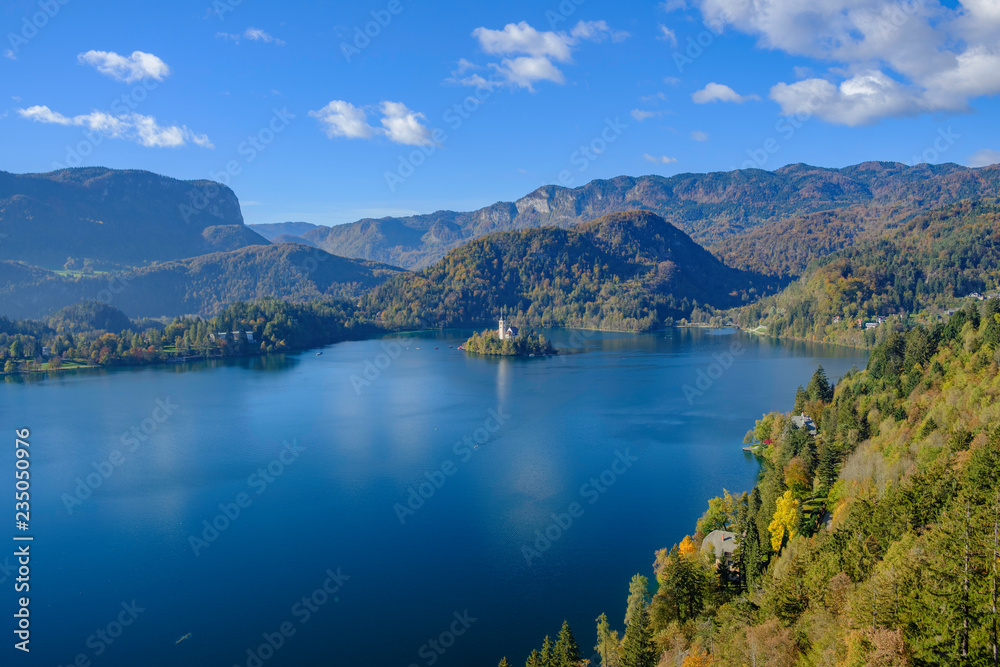 Scenic view of small island with church of the Assumption of Maria in center of lake Bled - the most popular hiking spot in Slovenia