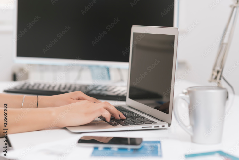  business woman working in her office on her laptop. Business concept