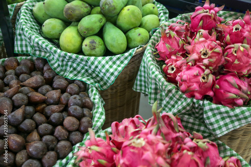 Fototapeta Naklejka Na Ścianę i Meble -  Fresh fruits at a local farmers market. 
Salak, mango and dragon fruit.
