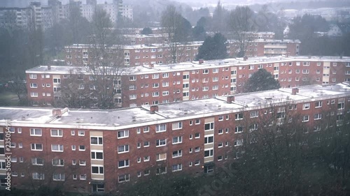 Residential districk roofs in foggy, snowy winter day view. photo