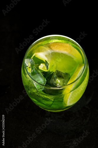 Green cocktail with gin  bitter lemon  basil and lemon
