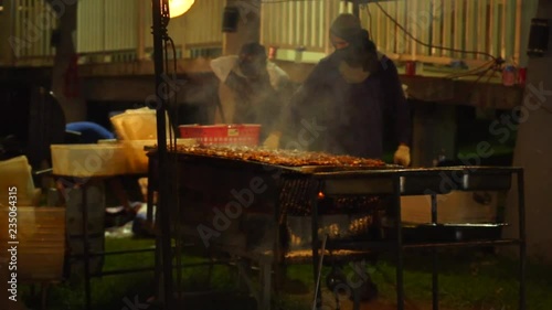 Cooks barbequing at Chamorro Village, Guam. Which is held every Wednesday night that attracts tons of tourists and locals with delicious local food. photo