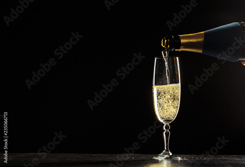 Fényképezés bottle of champagne and glasses over dark background