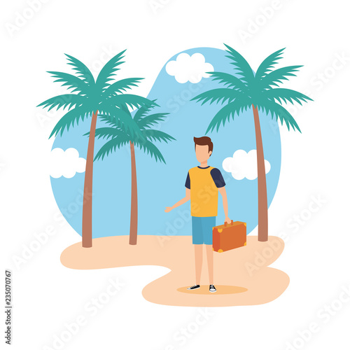 young man with suitcase on the beach