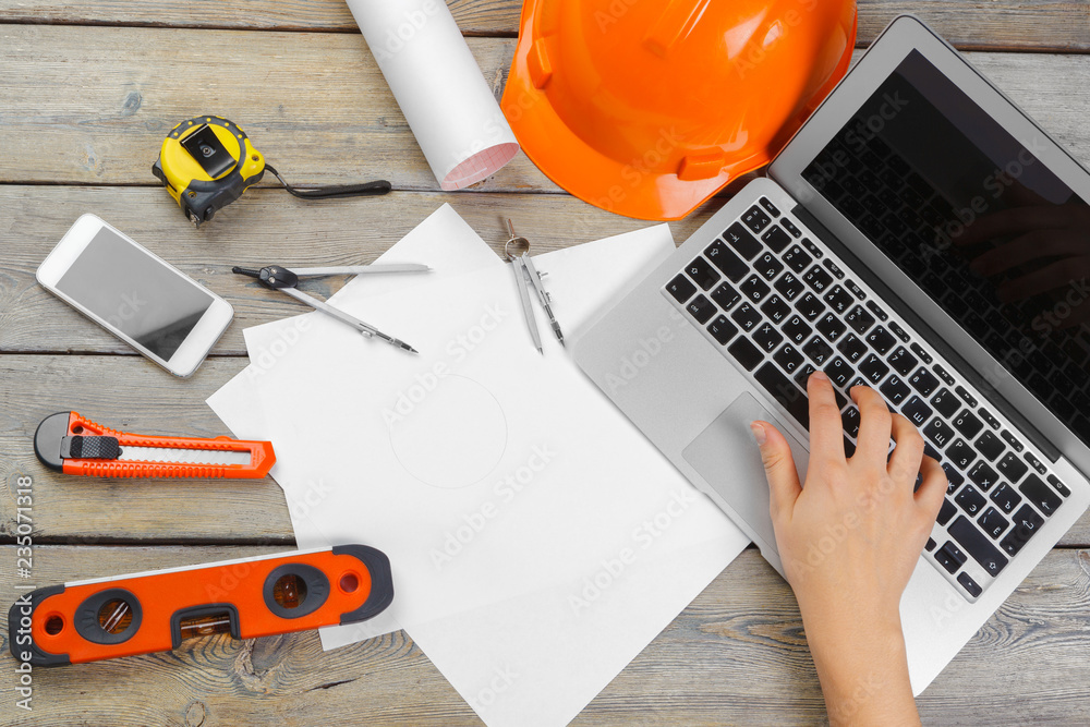 Architect workplace with open laptop and instruments top view
